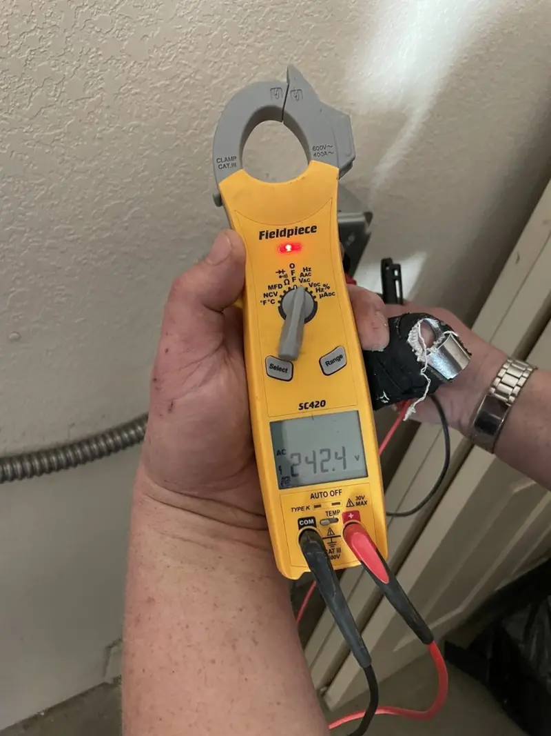 Voltage testing with clamp meter during Ceiling Fan Installation in Menomonie